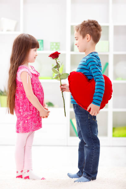 istock Little boyfriend giving flower 958126022