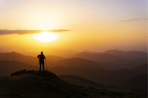 istock Man on top of mountain at sunset. Conceptual scene. 958126106