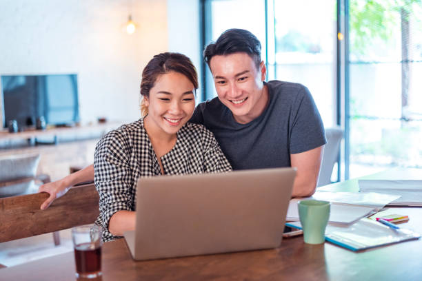 istock Young Asian couple at home 958130598