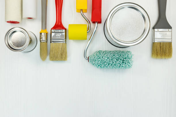 istock painting tools on wooden background. flat view 958130718