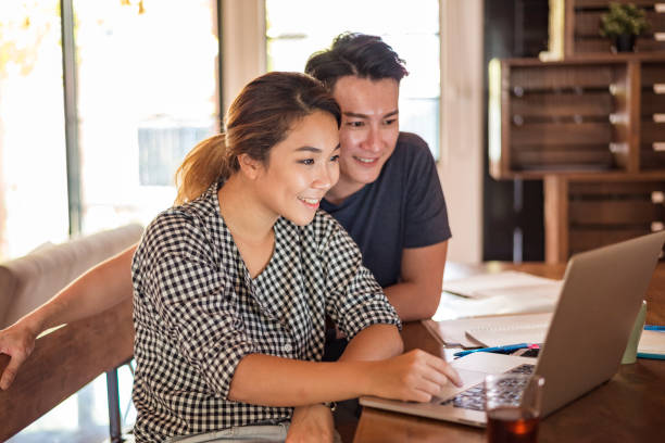 istock Young Asian couple at home 958131162
