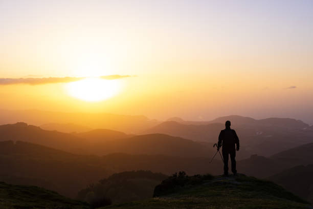 istock Man on top of mountain at sunset. Conceptual scene. 958131288