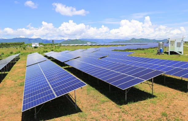 istock On Ground Solar Farm under Blue and Cloudy Sky Mountain Background 958132028