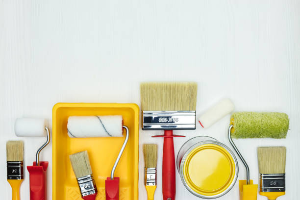 istock various paint brushes, rollers, paint cans and paint tray on white wooden background 958132728