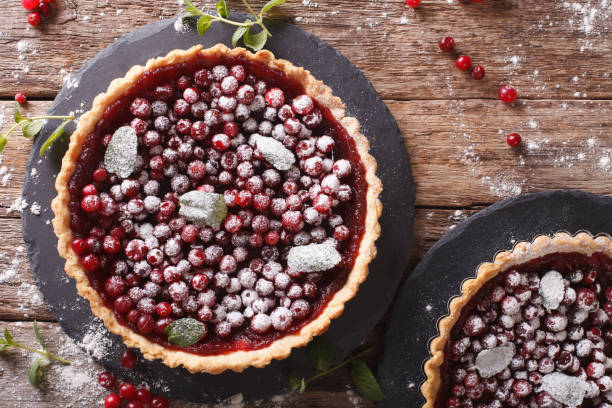 cranberry cake with jam, sugar, mint close-up on the table. horizontal top view - jellied cranberries fotos imagens e fotografias de stock