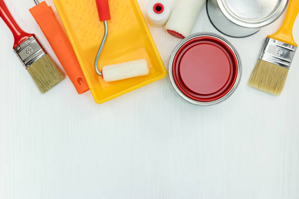 istock painting tools on white wooden background. flat view 958136484