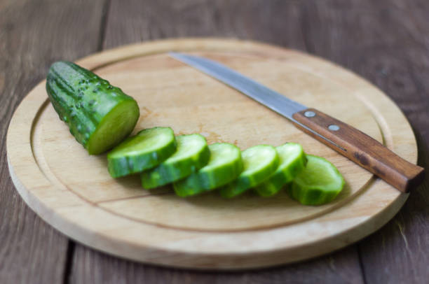 istock fresh green sliced cucumber for salad on a cutting Board 958138562