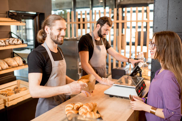 istock Bread sellers with client at the bakery shop 958138798