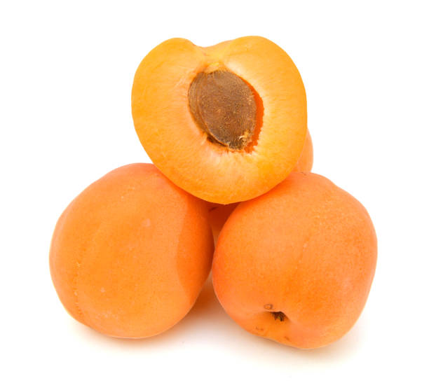 istock fresh yellow plums and a cut one on a white background 958150394