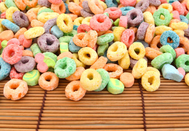 istock Delicious and nutritious fruit cereal loops flavorful on white background, healthy and funny addition to kids breakfast on bamboo mat 958151168