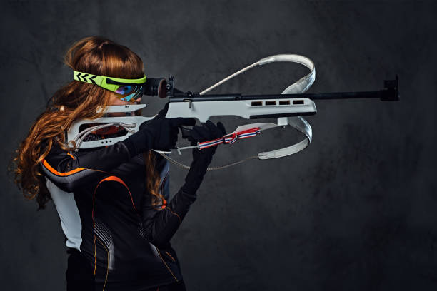 istock Redhead female Biathlon champion aiming with a competitive gun. 958154836