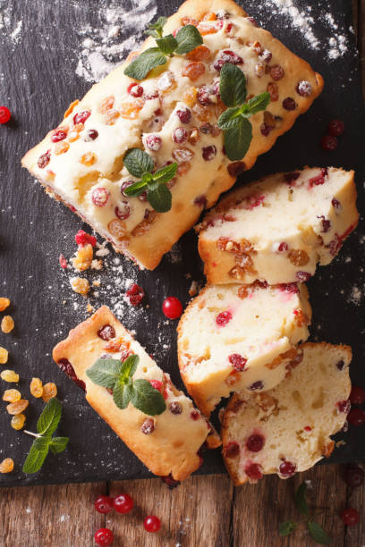 istock Traditional fruit cake with cranberries and raisins close-up. vertical top view 958159642