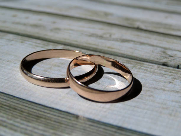 istock Wedding rings on wooden table 958162318