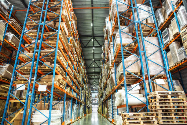 istock Warehouse or hangar storage racks or shelves with boxes and goods. Industrial logistic delivery and distribution 958166680