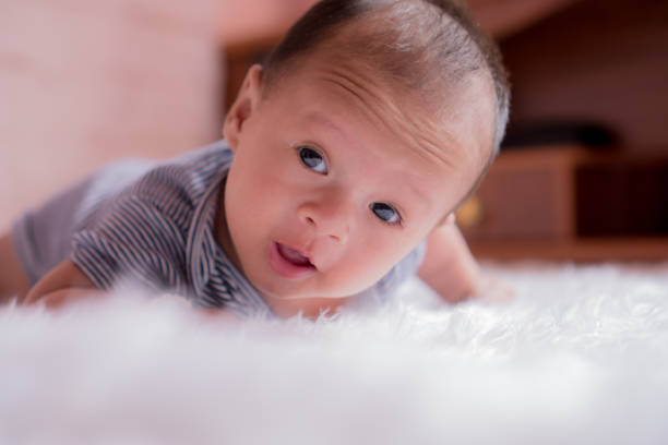 istock Asian babies Looks very cute and smiling. Lying on white floor. 958169624