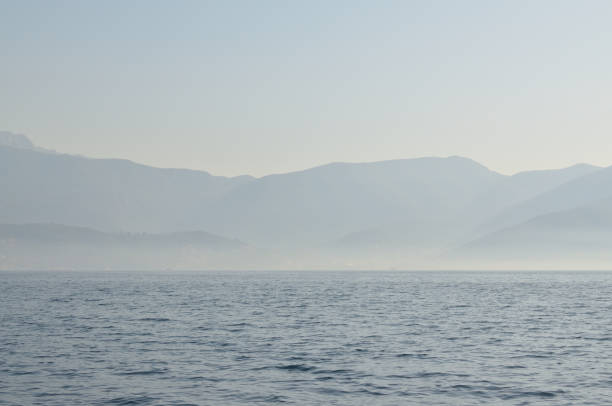 istock Sea and land in morning mist 958170086