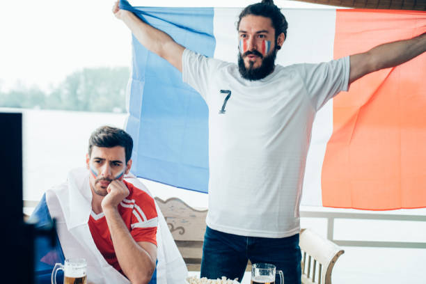 istock Friends watching soccer game on TV together 958172510