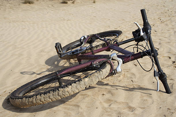 istock bike laying on a sand 95817494