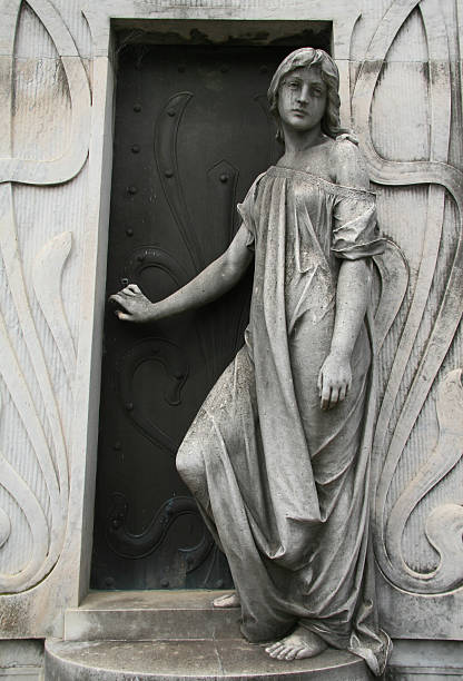 Weathered old angel statue in a cemetery