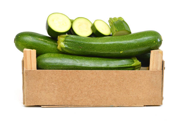 istock fresh zucchini's (Cucurbita pepo) in a wooden crate on a white background 958188402