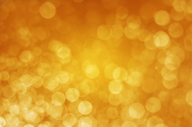 istock abstract yellow gold bokeh glitter sparkle background. 958188760