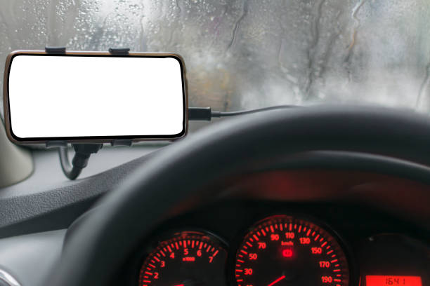 istock Driving a car with smartphone in holder 958199054