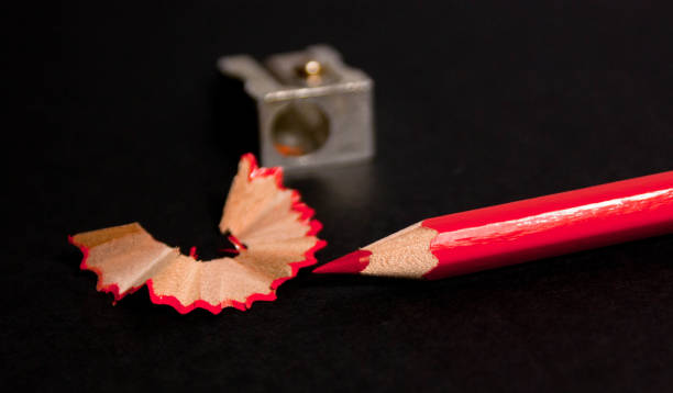 istock red pencil with pencil shavings and pencil sharpener up close 958201686