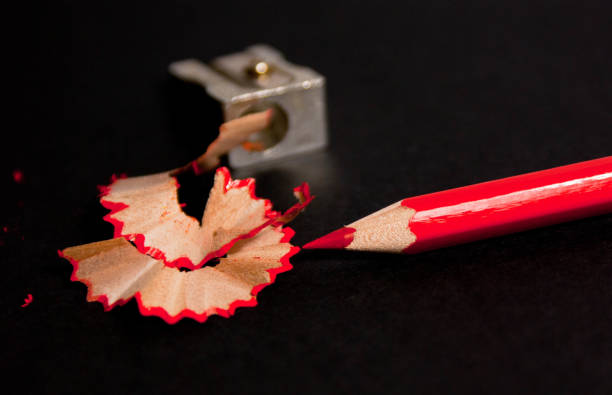 istock red pencil with pencil shavings and pencil sharpener up close 958201694