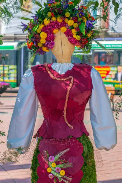 Photo of Floral decoration with a wooden statue dressed in a popular costume made of flowers