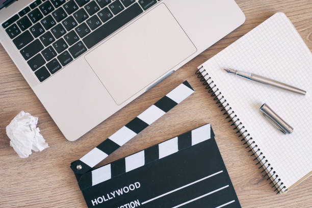 istock Video Editing,Movie clapper laptop and pencil notepad on the wood table 958208908