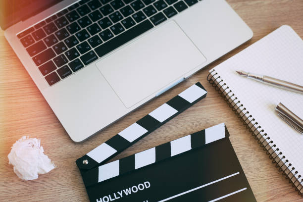 istock Video Editing,Movie clapper laptop and pencil notepad on the wood table 958209308