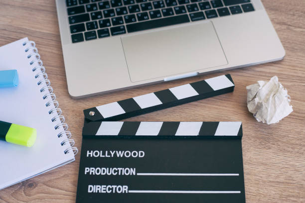 istock Video Editing,Movie clapper laptop and pencil notepad on the wood table 958209310
