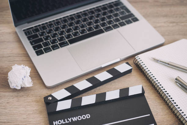istock Video Editing,Movie clapper laptop and pencil notepad on the wood table 958209364