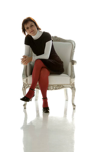Woman Sitting on a White Chair