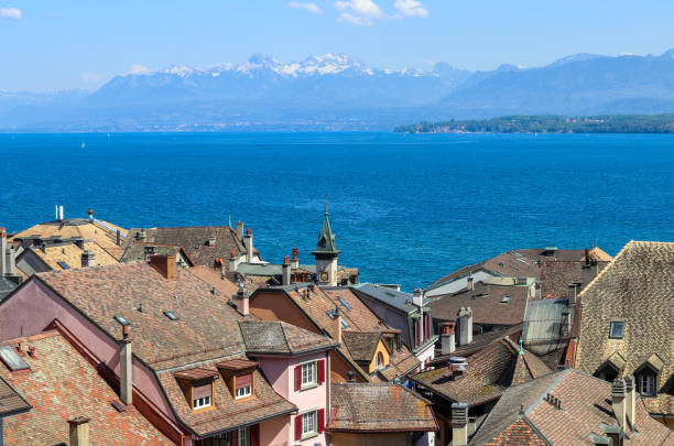 Beautiful view at Geneva lake and french Alps mountains with snow tops through roofs of old town of Nyon, Switzerland Beautiful view at Geneva lake and french Alps mountains with snow tops through roofs of old town of Nyon, Switzerland lake seneca stock pictures, royalty-free photos & images