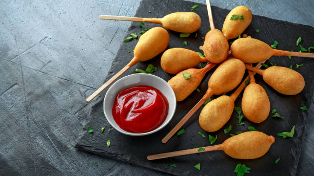 istock Mini Corn Dogs on stone platter with ketchup 958213416