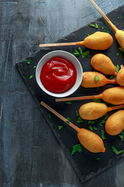 istock Mini Corn Dogs on stone platter with ketchup 958213460