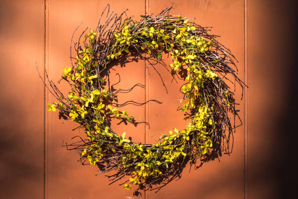 istock Forsythia wreath on wooden door 958213974