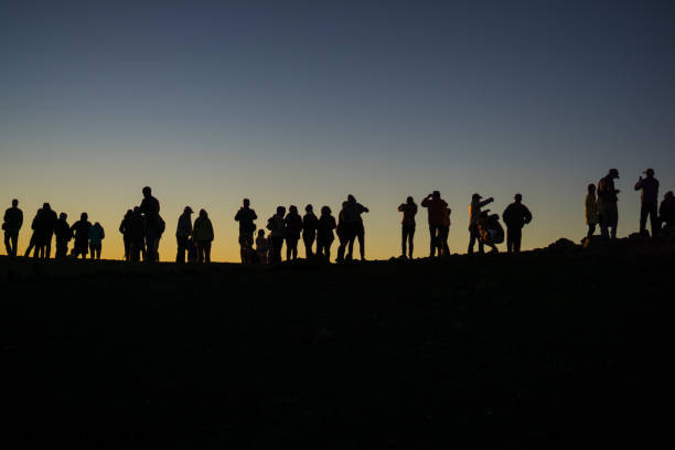 istock Silhouette of observers watching the sunset 958216738