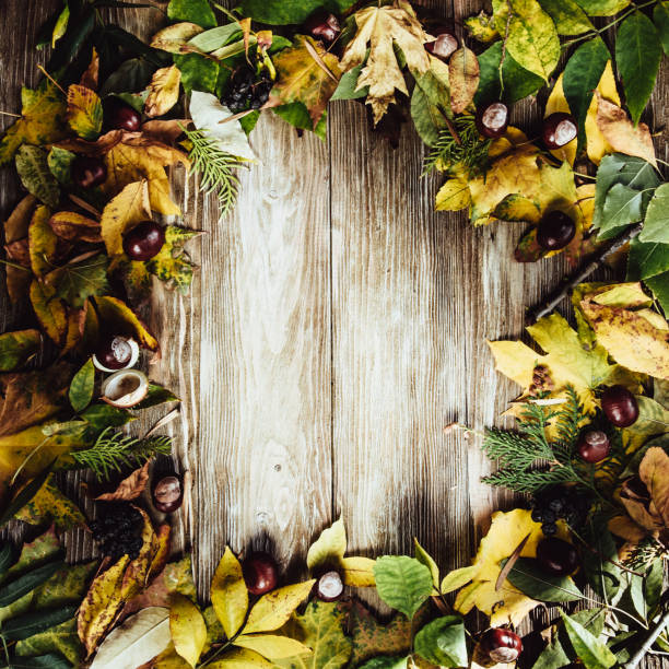 istock Autumn wooden background with maple leaves with copy space 958218382