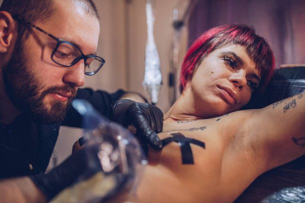 istock Beautiful girl getting a tattoo 958221398
