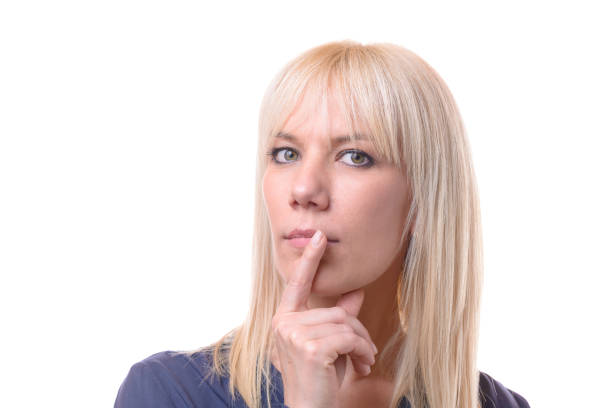 istock Thoughtful woman with her finger to her lips 958225560