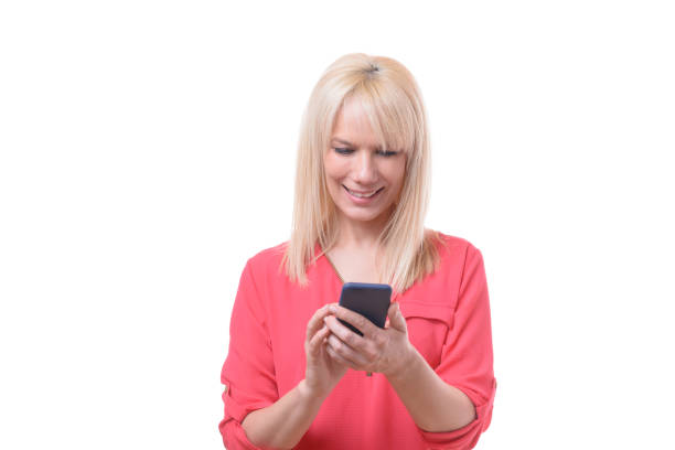istock Beautiful blond woman texting on her mobile 958225742
