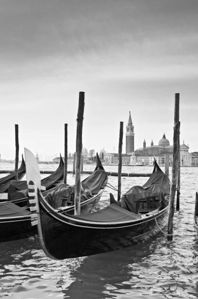 istock Moody monochrome image of gondolas St Marks Square Venice Italy 958228932