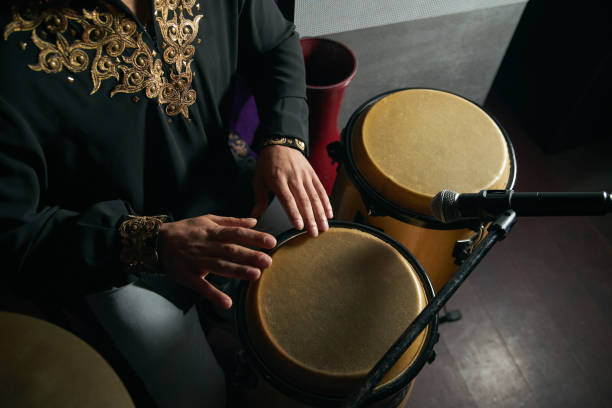 istock Man hands playing music at djembe drums 958228938