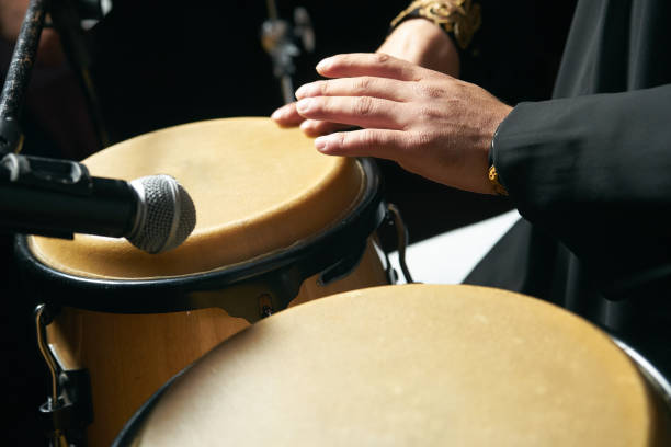 istock Man hands playing music at djembe drums 958229180
