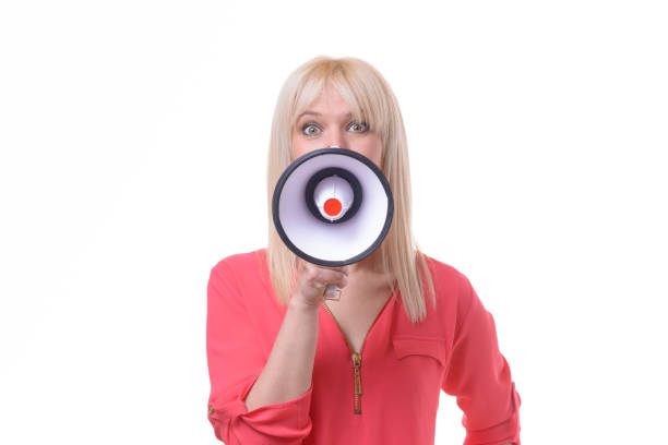 istock Young blond woman yelling into a megaphone 958229202