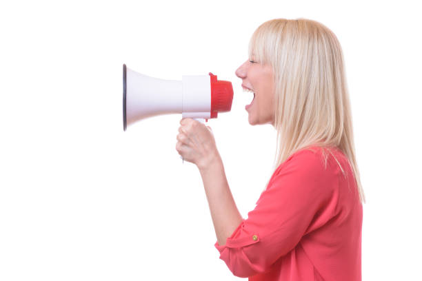 istock Young blond woman shouting into a megaphone 958229280