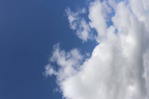 istock Close up of fluffy white clouds against blue sky 958233306