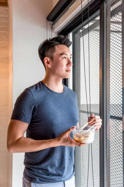 A portrait of a modern man while drinking iced coffee in cafe.